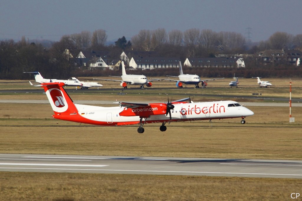 Die De Havilland Dash 8-400 D-ABQI von Air Berlin bei der Landung in Dsseldorf am 9.3.2010. Im Hintergrund sind u.a. zwei A320 der insolventen Bluewings zu sehen.
