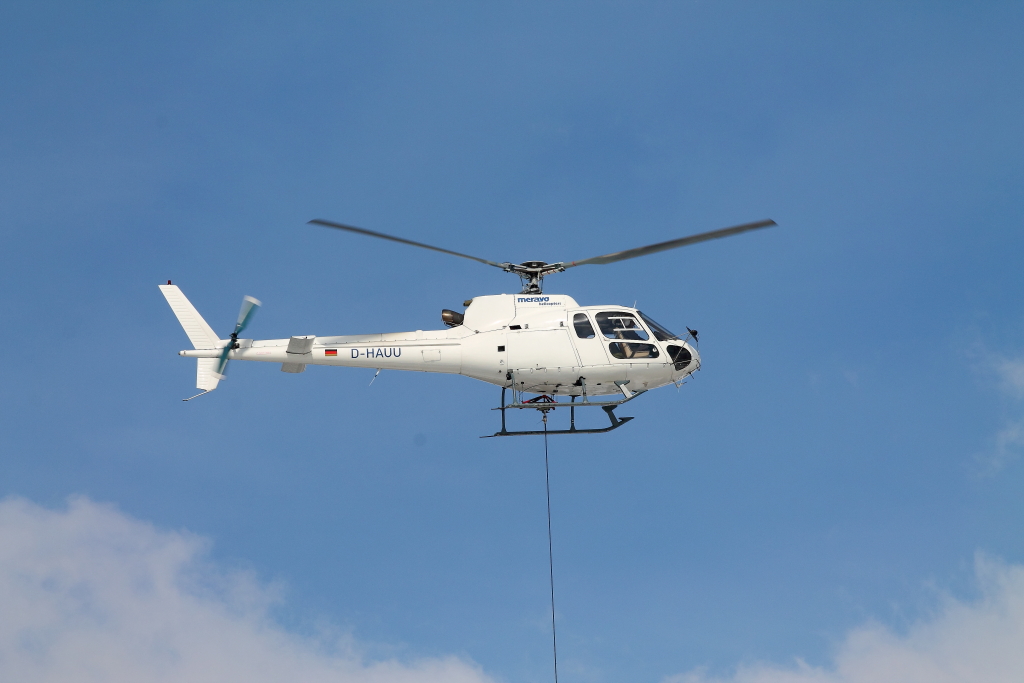 Eurocopter AS 350 B 1 der Meravo Luftreederei D-HAUU beim Kranflug fr Eisenbahnbaustelle der STRABAG AG in Nassenheide 26.03.2013.