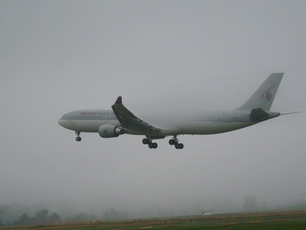 Qatar Airways Airbus A330-303 erscheint kurz vor der Landung auf RW 14 aus einer Nebelwand (4.8.2010).