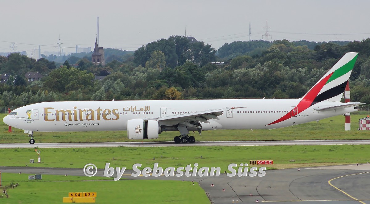 Emirates B777-300ER A6-EGN is slowing down on rwy 23R at Dusseldorf. Inbound from Dubai.4.7.14
