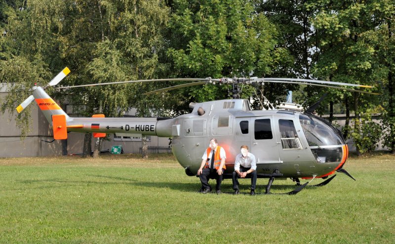 Bo-105 - D-HUBE. 2 Mitarbeiter sitzen (wie auf dem  Kackstuhl ) auf dem Landegestell und warten auf den Feierabend. Aufgenommen am 20.09.2009 beim Tag der Deutschen Luft- und Raumfahrt in Kln-Porz. 