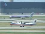 Eine ATR 42 der American Eagle beim Start, whrend im Hintergrund eine MD-83 der American nach der Landung abbremst.