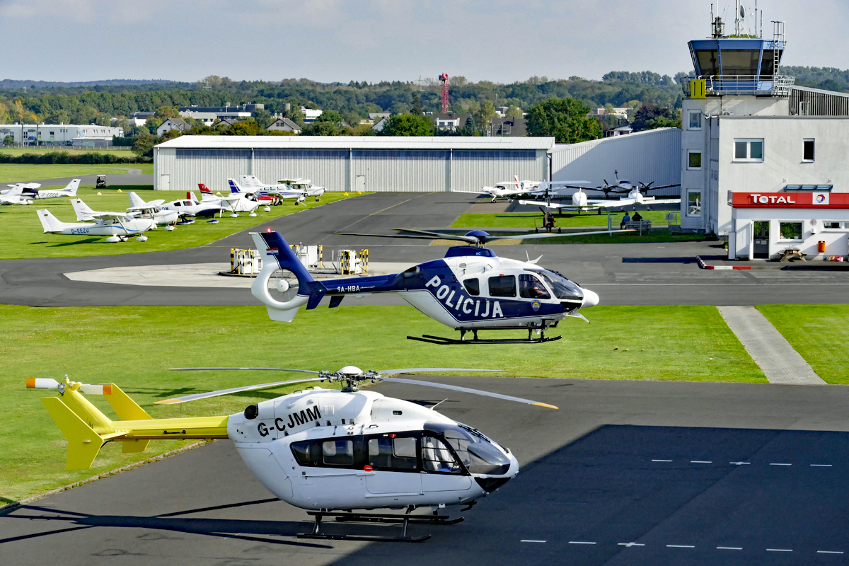 Flugbetrieb in Bonn-Hangelar, im Vordergrund die Helis EC 145 G-CJMM und EC 135P-2, 9A-HBA - 27.09.2017