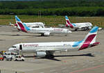 Ein  Rudel  Eurowings von drei A 320 und einer B 737 auf dem Vorfeld von CGN.