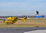 BK 117 D-HTIB des ADAC und Hughes 300 beim Vorbeiflug in Bonn-Hangelar, 09.02.2011