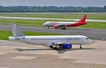 A 320-200 der  White Airlines  CS-TQK und A 320 der Air Berlin auf den Rollwegen in Dsseldorf - 07.06.2010